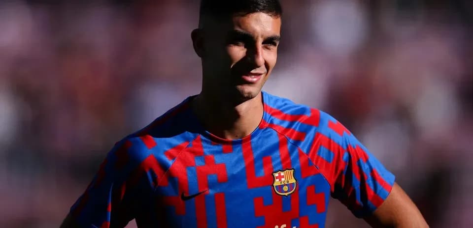 Football player in Barcelona jersey smiling