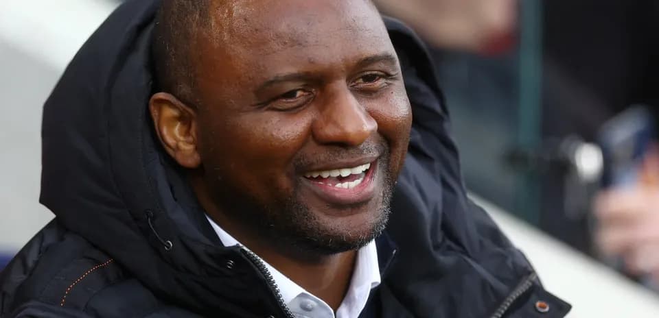 Man smiling in a sports jacket during event
