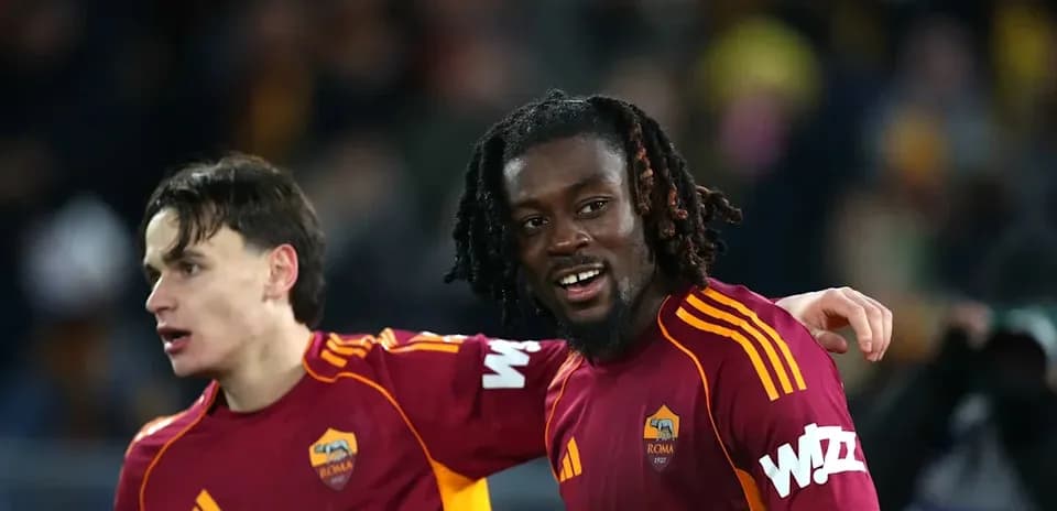 Two AS Roma players celebrating on the field
