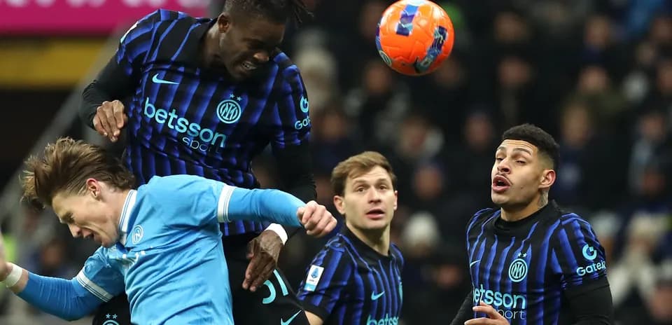 Players contesting a header during a football match