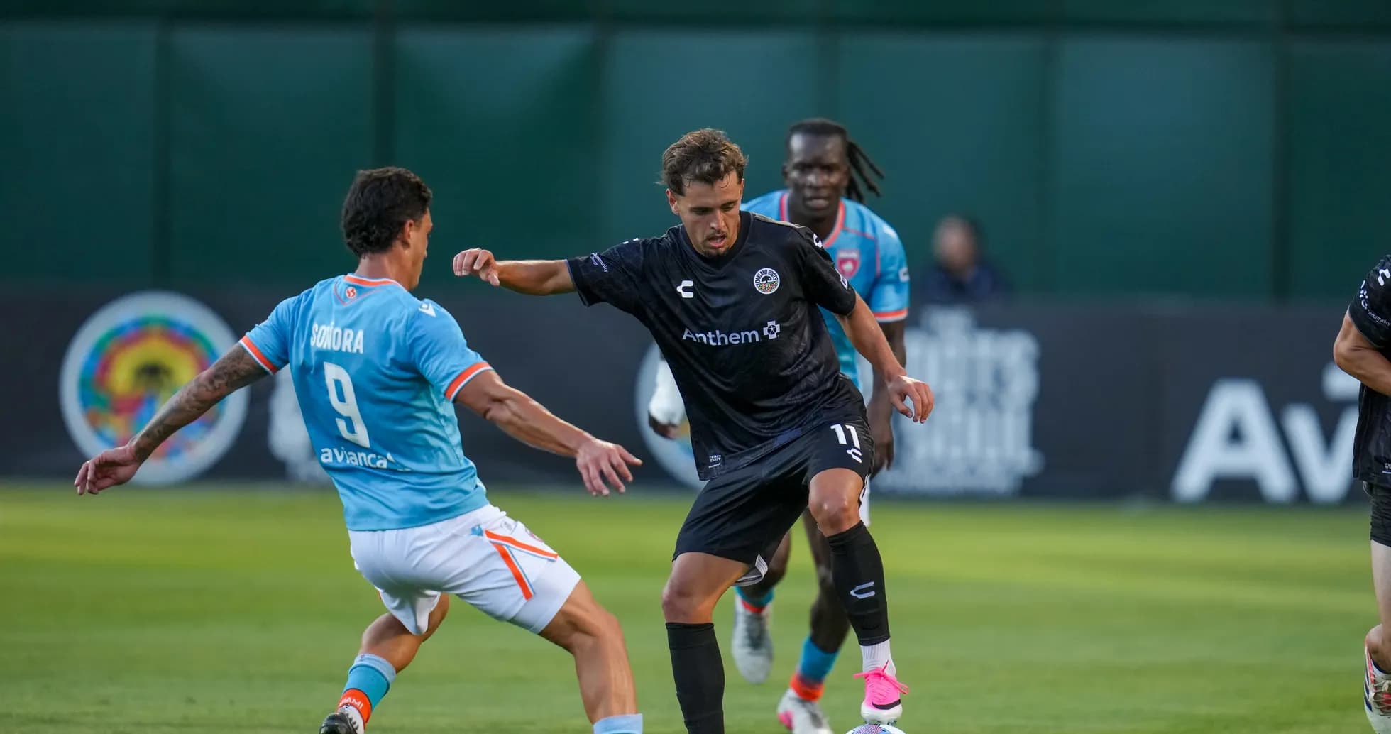 Player dribbling past opponent during match