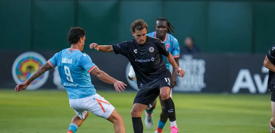 Player dribbling past opponent during match