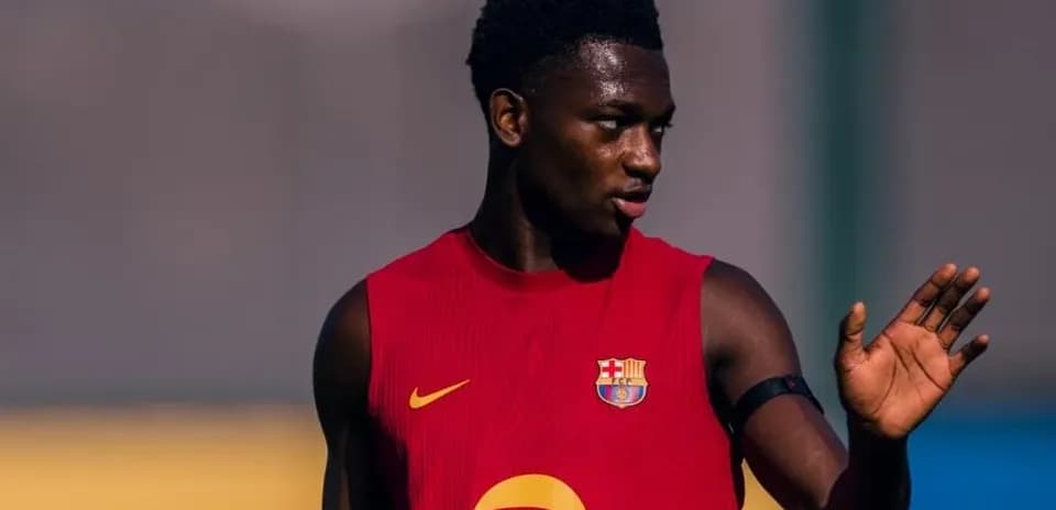 Player in red training kit gesturing during practice