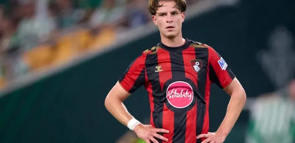 Player in red and black jersey standing on field