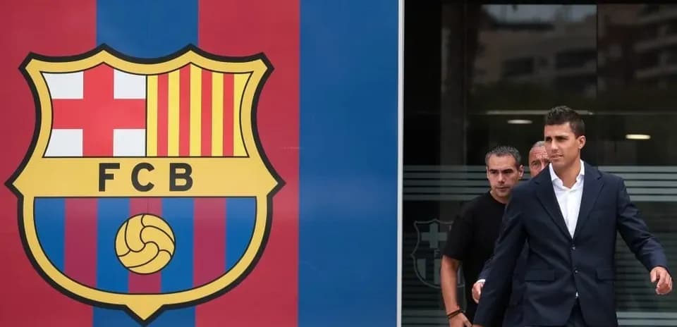 Player exiting building next to FC Barcelona logo