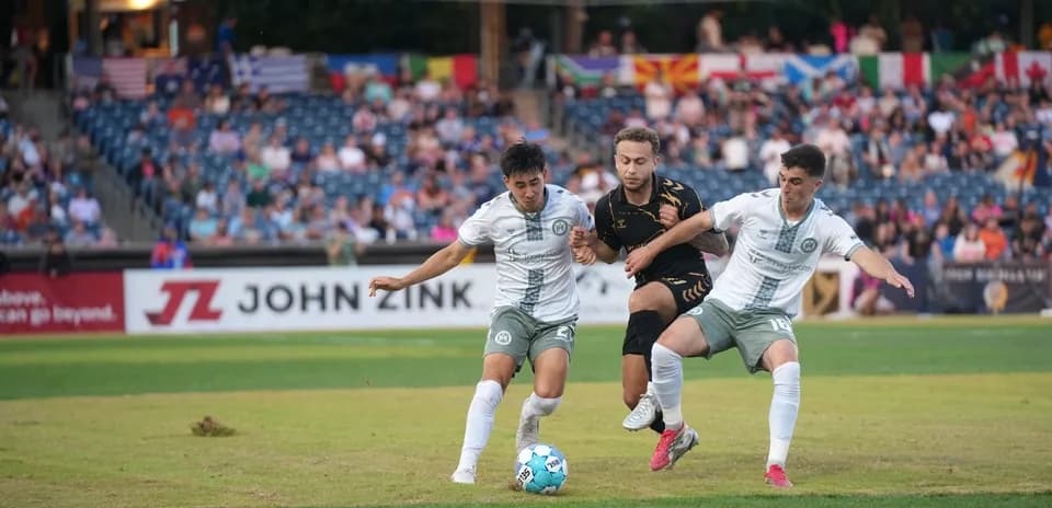 Players competing for the ball during USL match