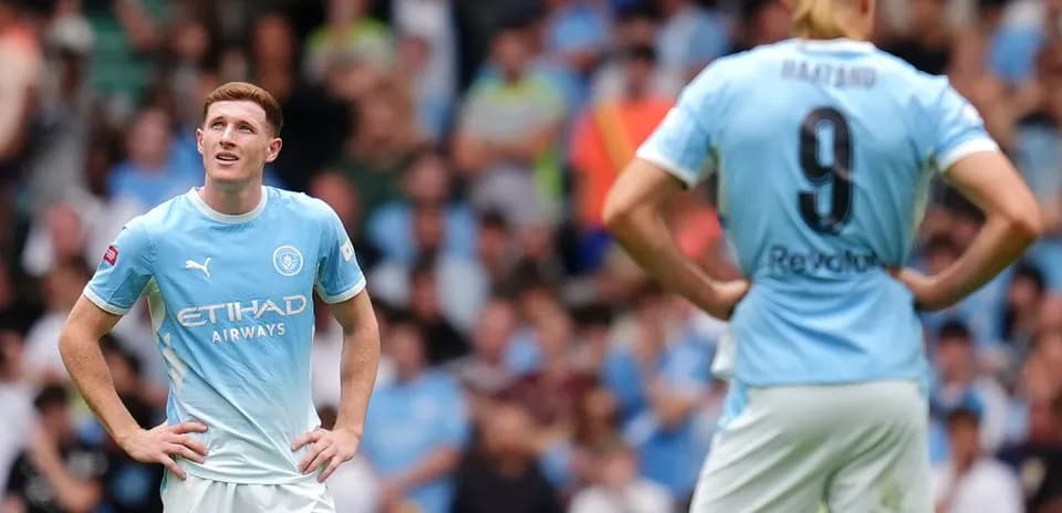 Manchester City players during a match, looking concerned