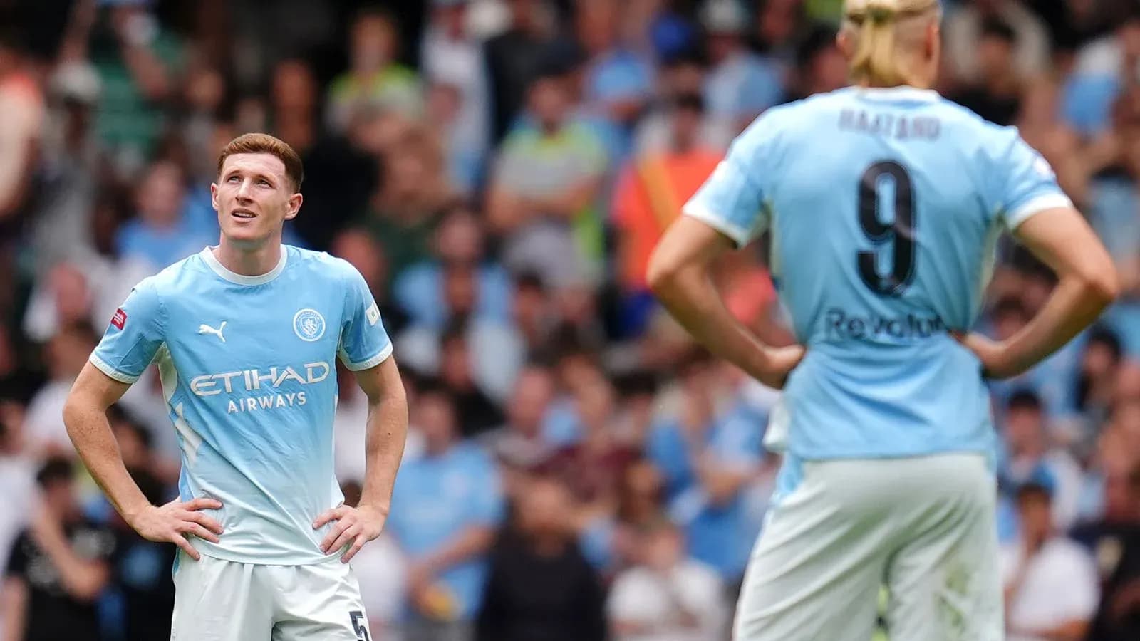 Manchester City players during a match, looking concerned