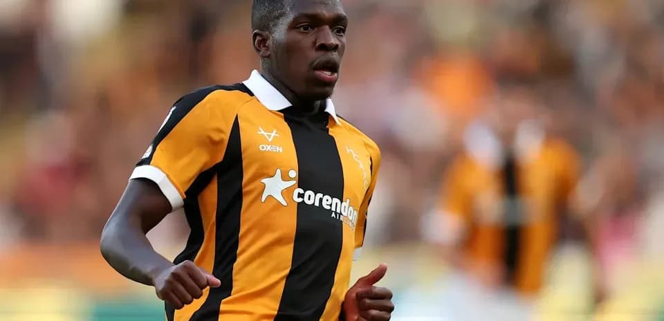 Player in black and orange jersey running on field