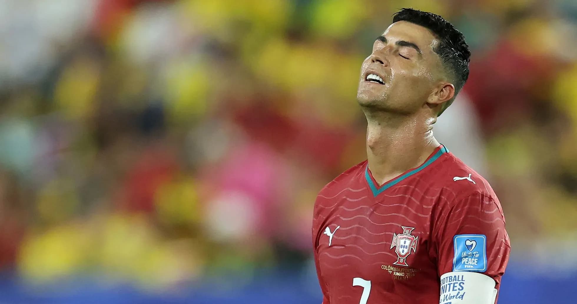 Player in red jersey looking upwards during match