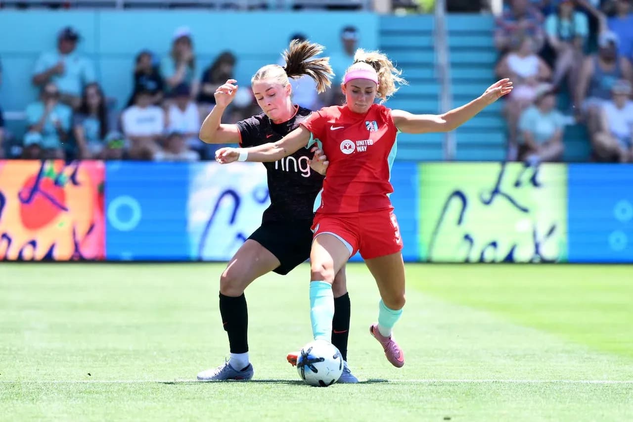 Two players competing for the ball in NWSL match