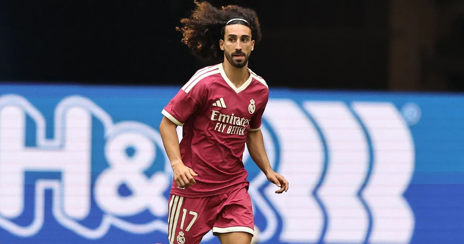 Player in pink Real Madrid kit running on field