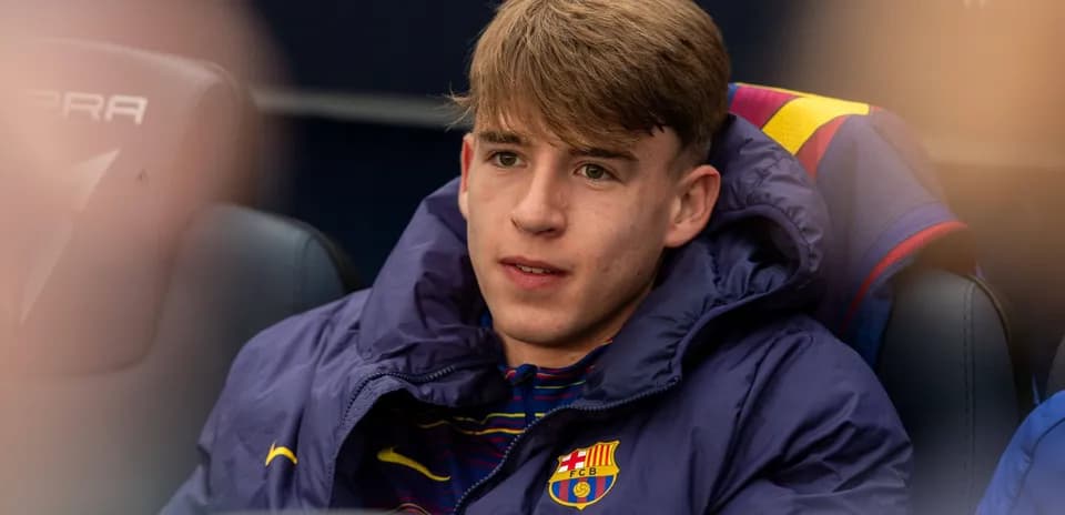 Barcelona player sitting on bench during match