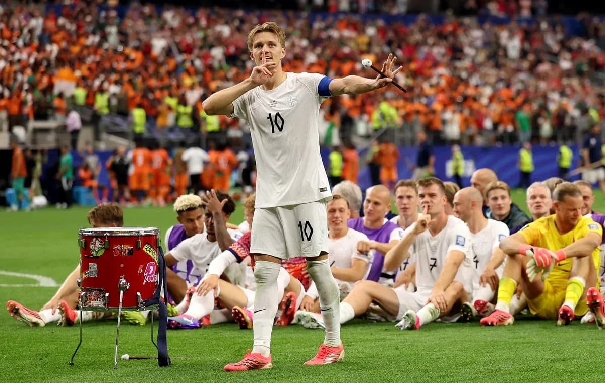 Player gesturing to crowd with teammates seated behind