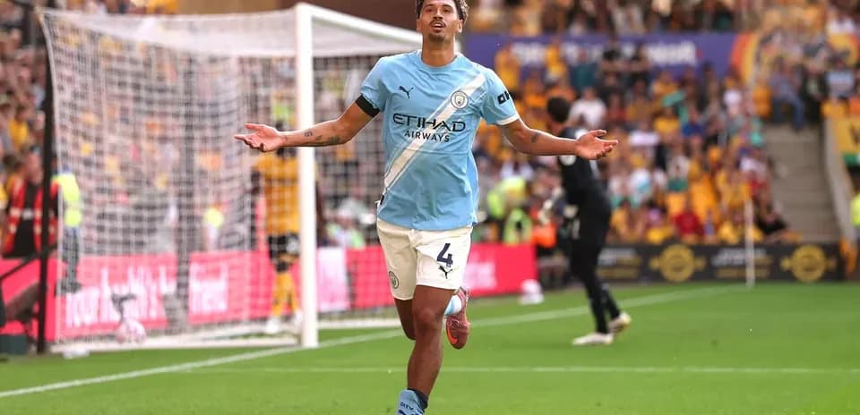 Player celebrating goal on the pitch at stadium