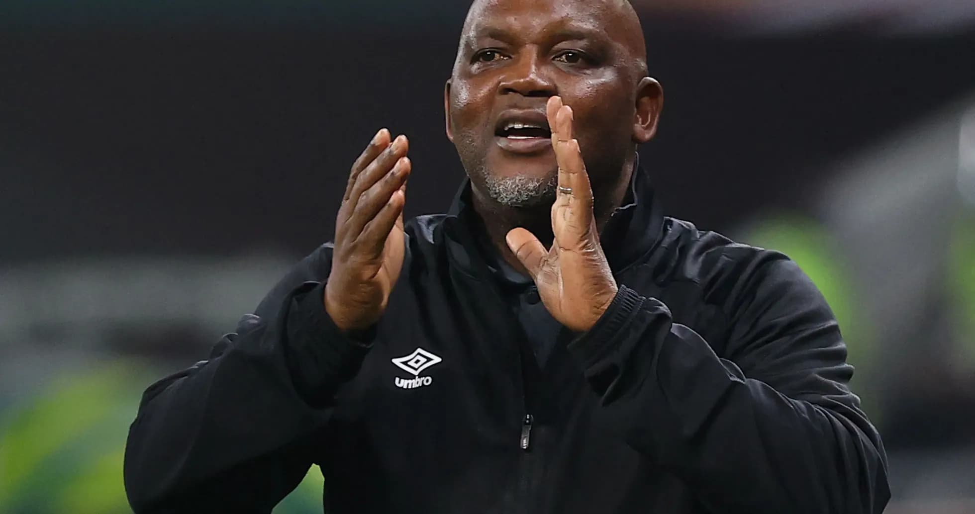 Coach gesturing during a match on the sidelines