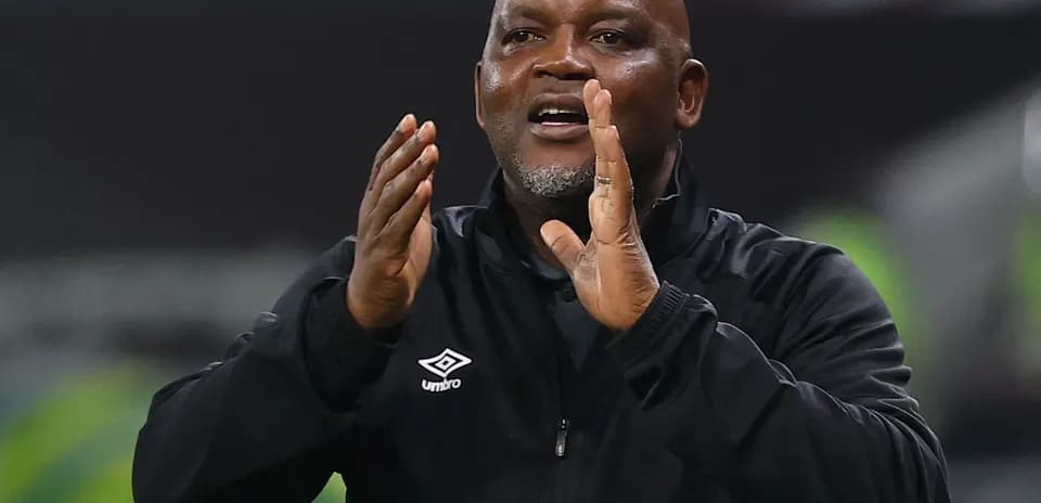 Coach gesturing during a match on the sidelines