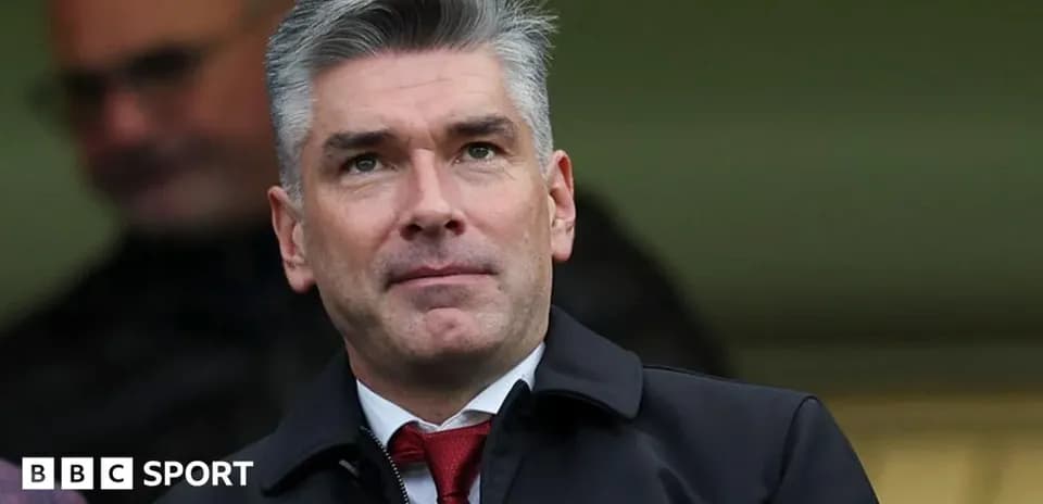 Man in suit observing from stadium seating area