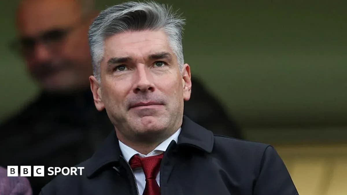Man in suit observing from stadium seating area