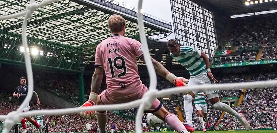 Goalkeeper blocking shot during Celtic match