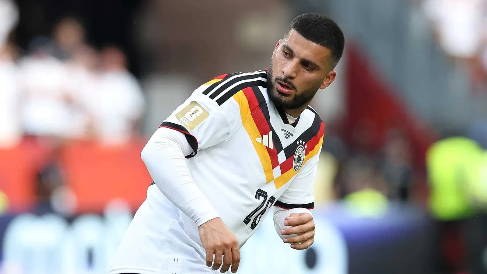 Player in Germany jersey warming up on field