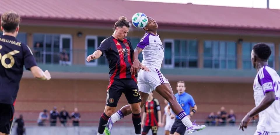 Players contesting a header during match action