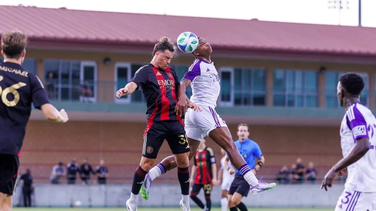 Players contesting a header during match action