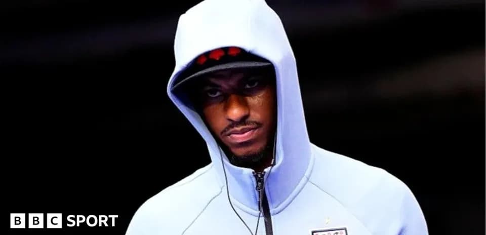 Player wearing a hooded sweatshirt before match