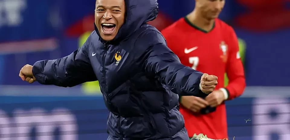Kylian Mbappé celebrating in warm-up jacket