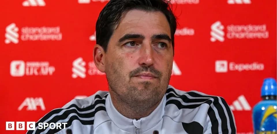 Manager speaking at press conference with sponsor backdrop