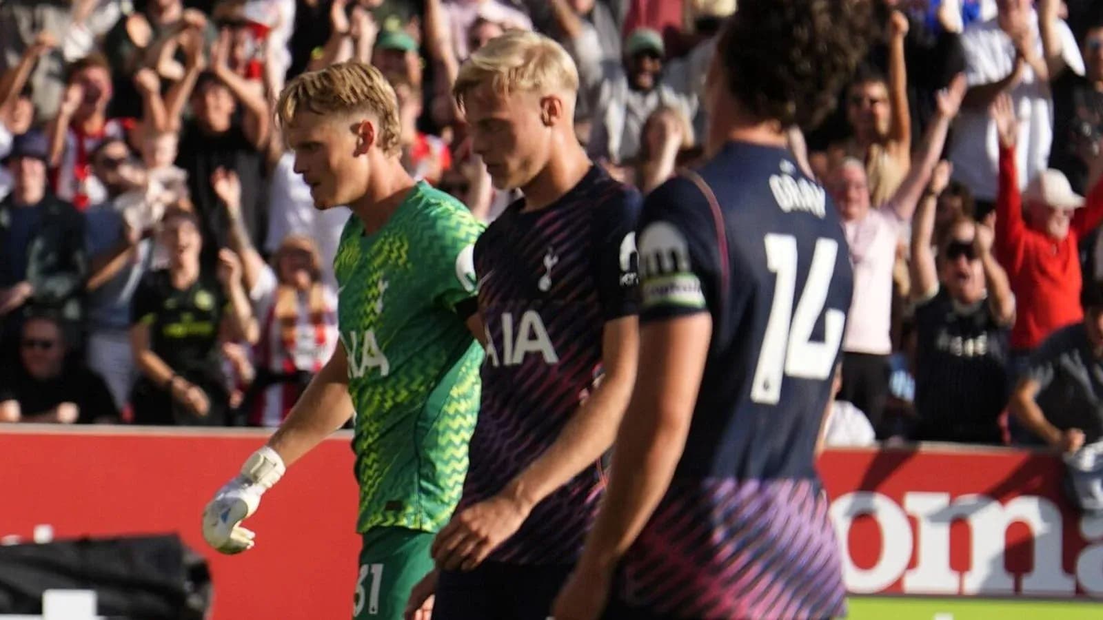 Tottenham players walking off field with fans cheering
