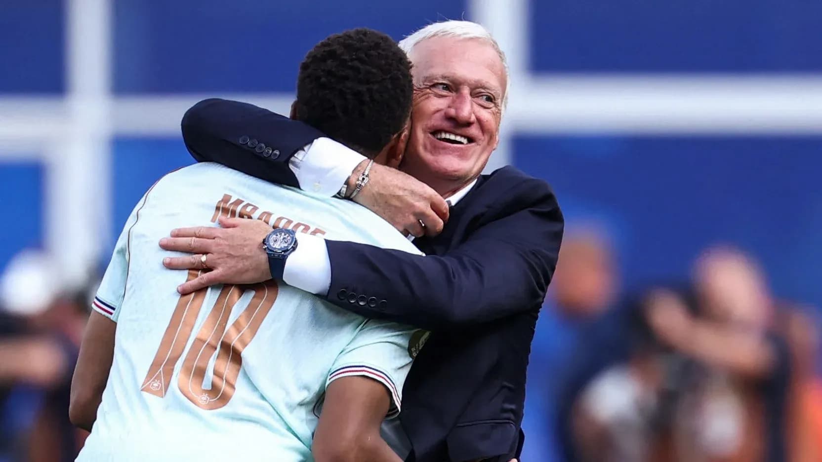 Player and coach embracing after match victory