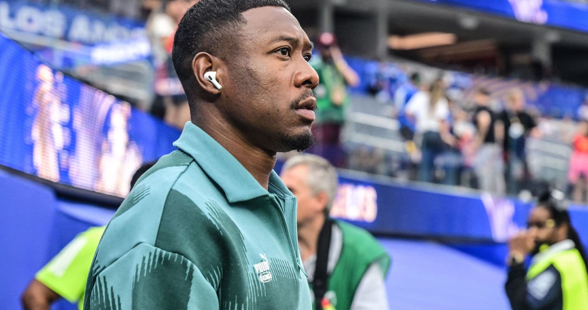 Player wearing headphones in stadium before match
