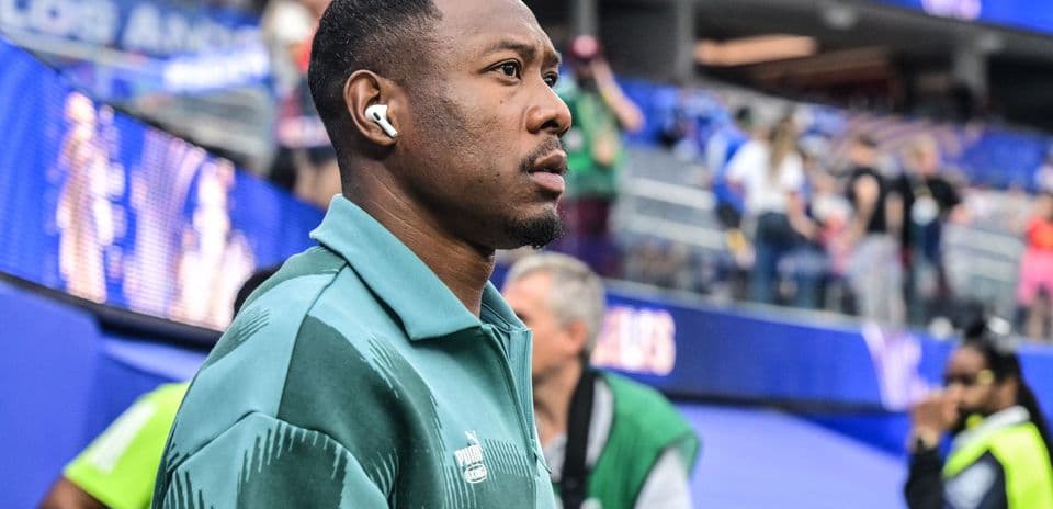 Player wearing headphones in stadium before match