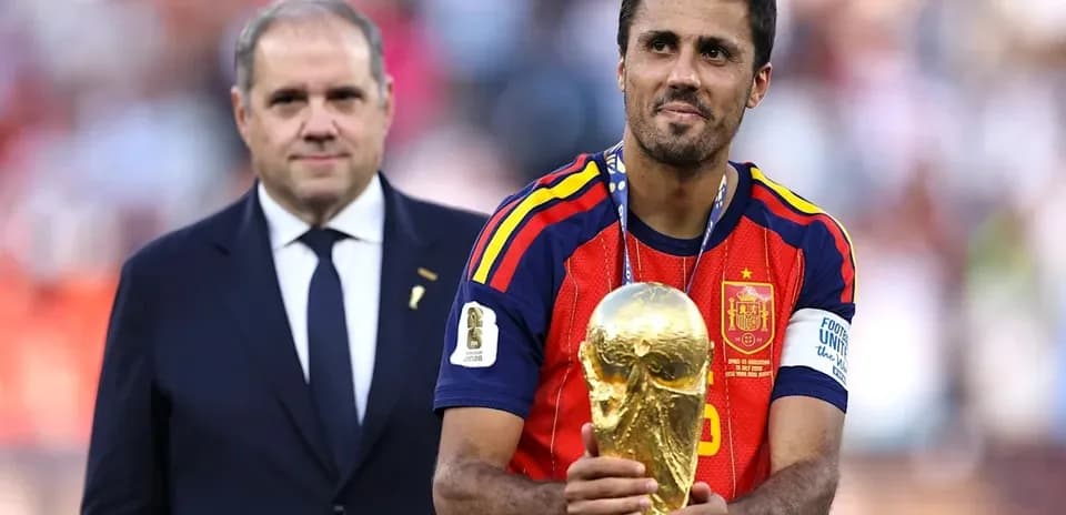 Player holding World Cup trophy with official beside