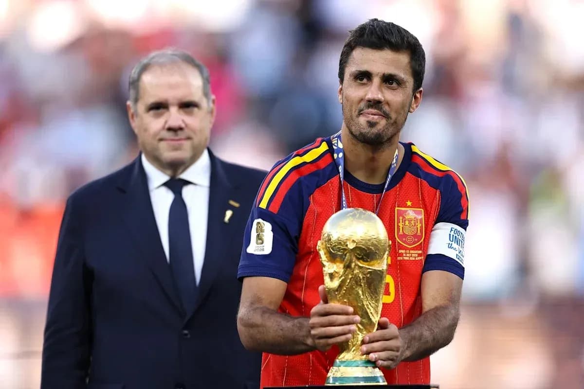 Player holding World Cup trophy with official beside