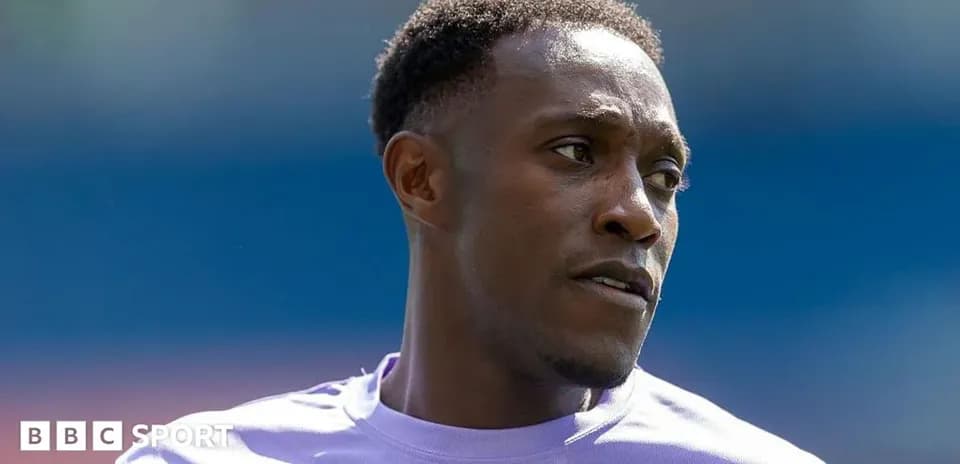 Football player in purple kit during warm-up