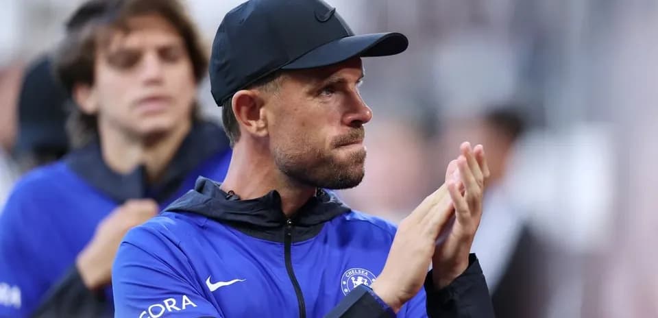 Coach applauding during a match on the sidelines