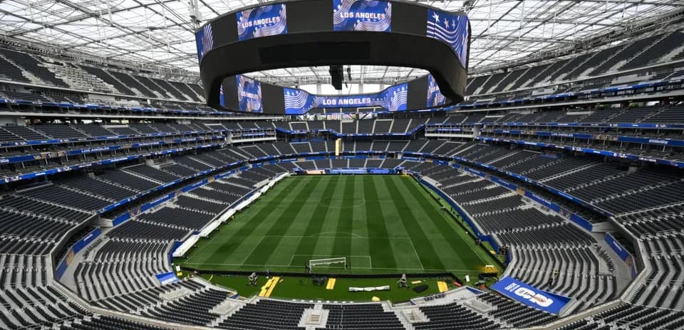 Empty stadium view with field and large screens