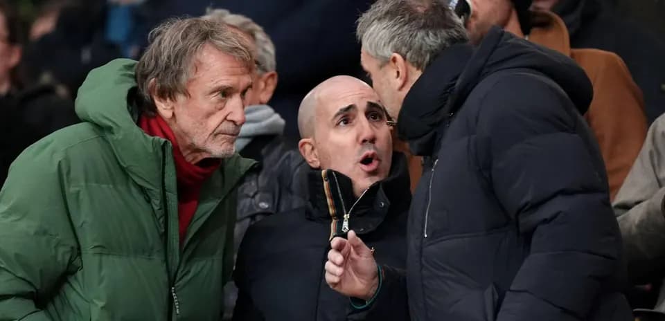 Three spectators engaged in conversation at a match