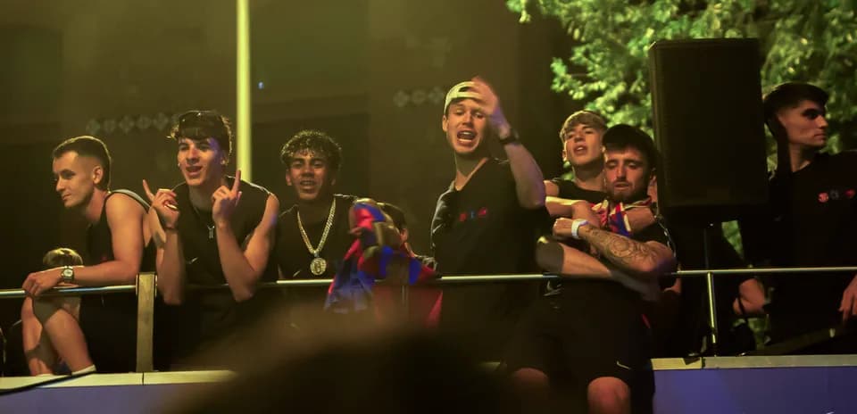 Group of fans celebrating on a balcony