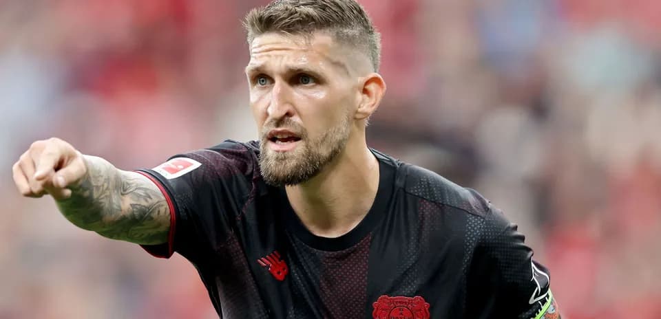 Player pointing during match wearing Bayer Leverkusen kit