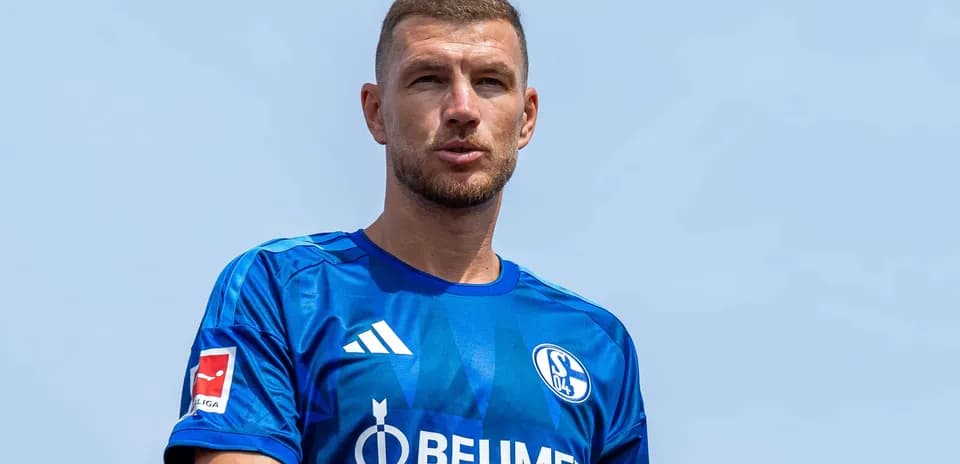 Player wearing blue Schalke 04 jersey outdoors