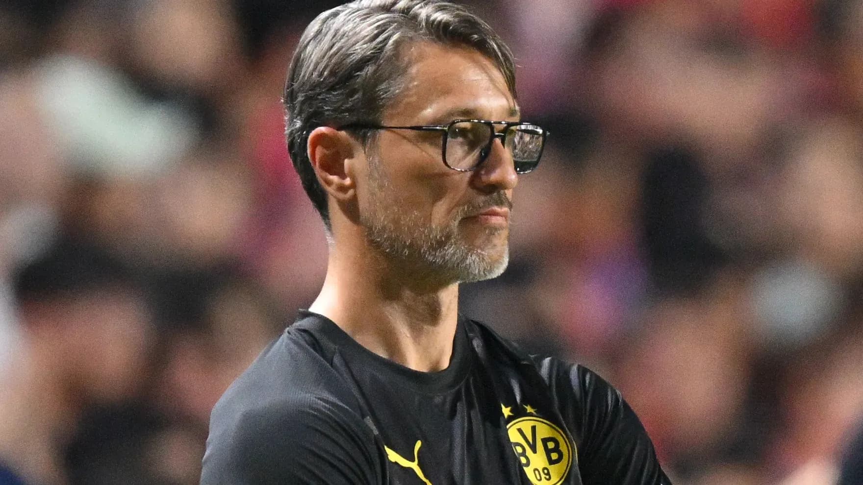 Coach observing the match from the sidelines
