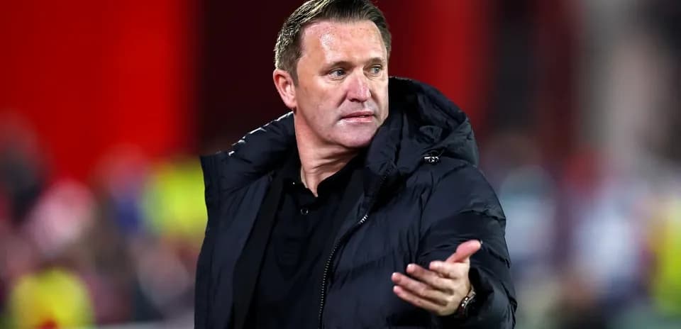 Coach gesturing during a football match on sideline