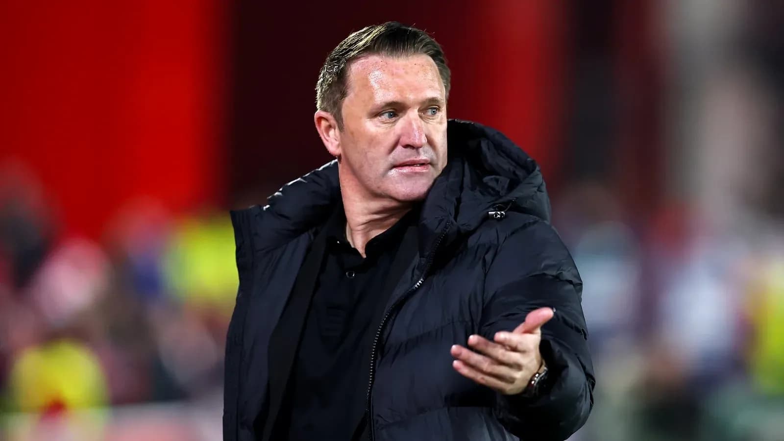 Coach gesturing during a football match on sideline