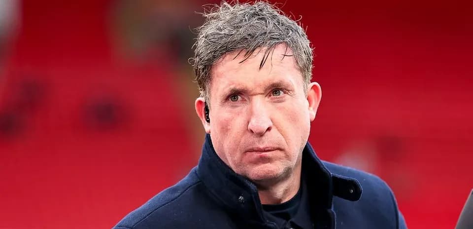 Man with short hair wearing a dark coat