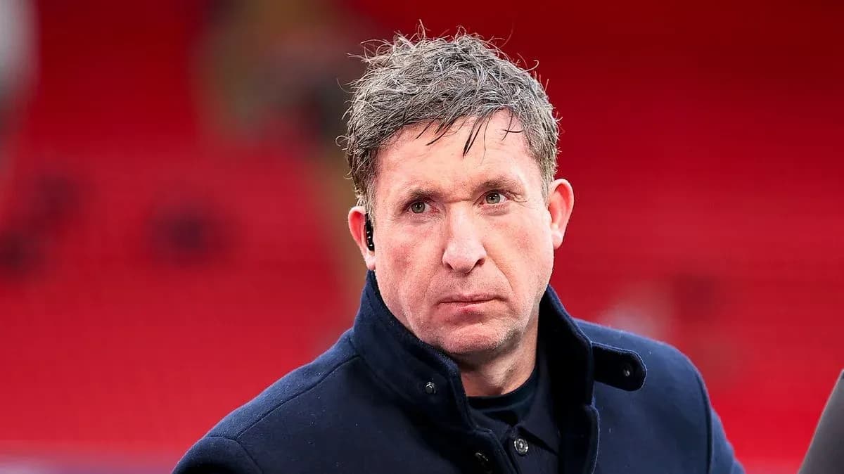 Man with short hair wearing a dark coat