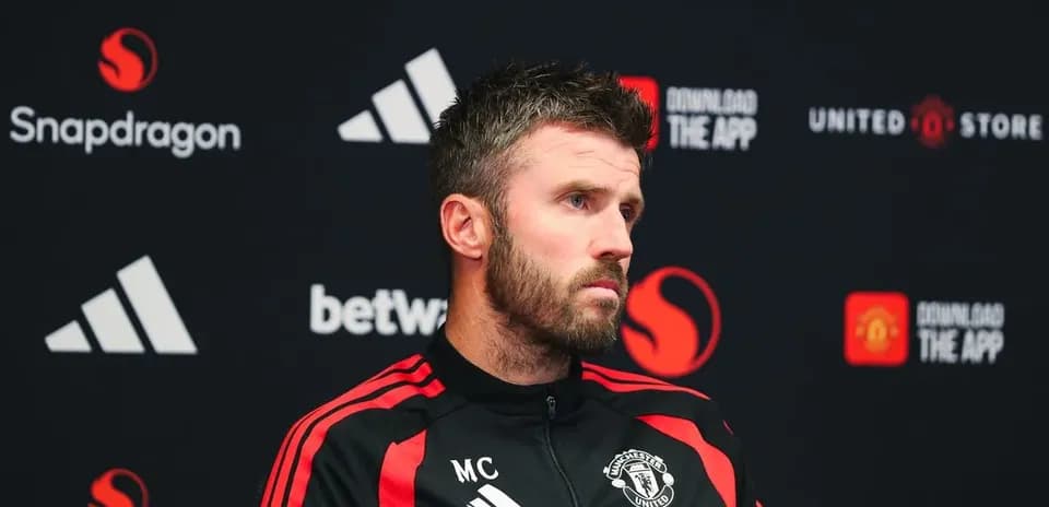 Manchester United coach at press conference podium