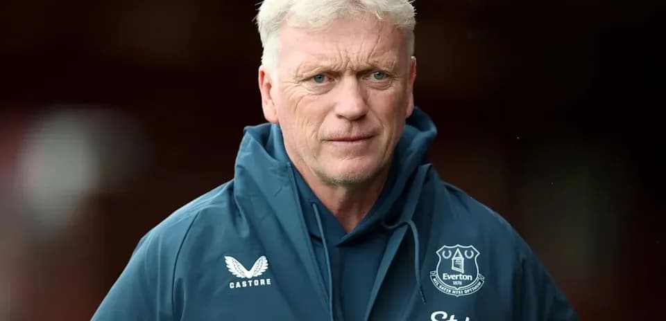 Manager wearing Everton jacket on the pitch